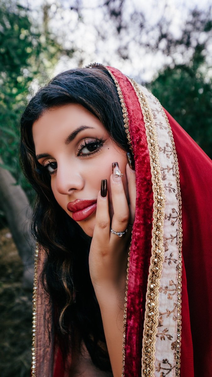 A woman in traditional indian attire with ornate gold trim