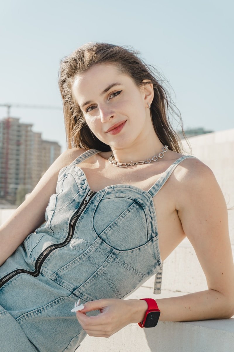 Young woman in denim dress wearing a watch