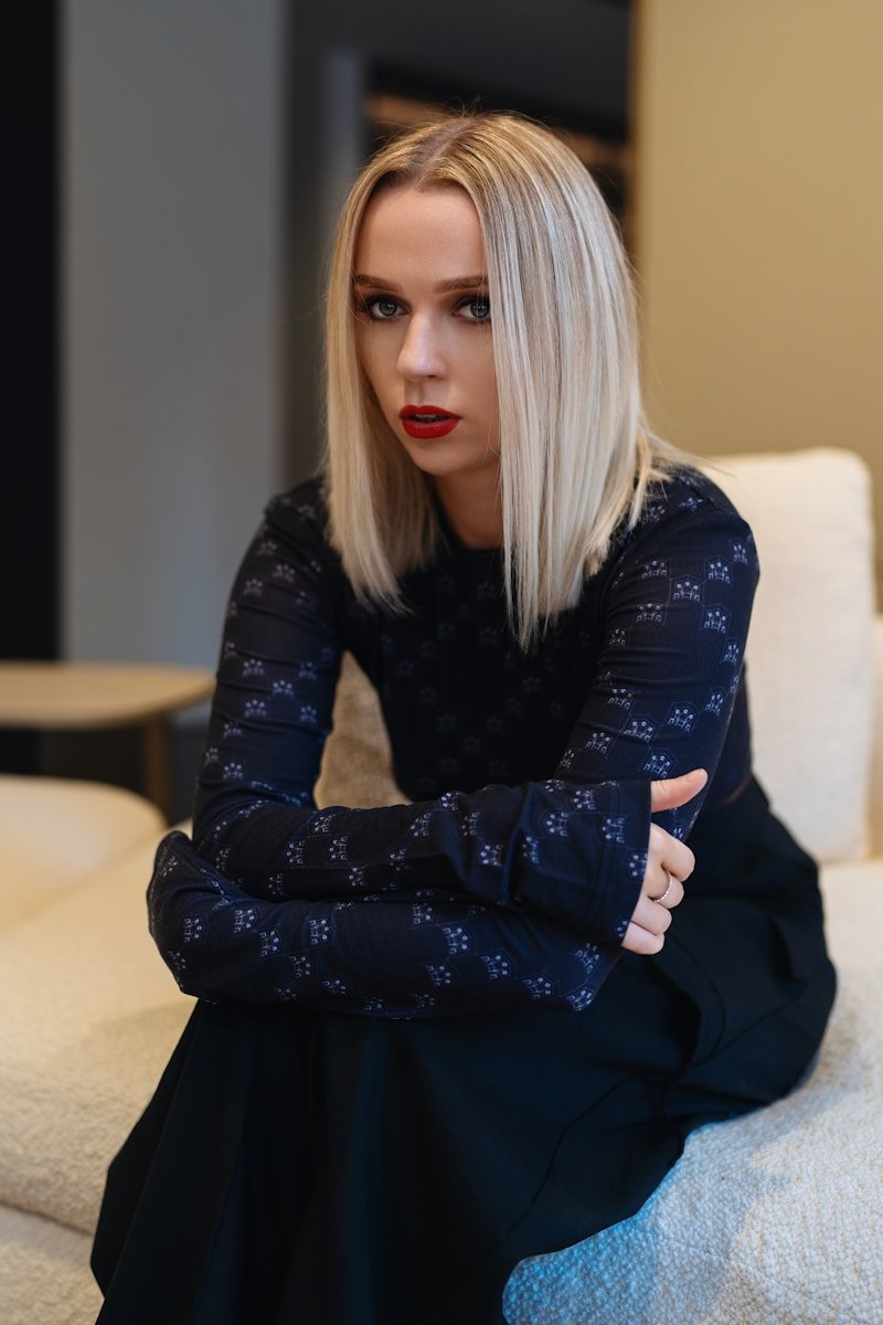 A woman sitting on top of a white couch